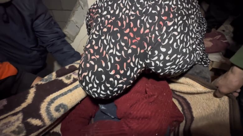 Woman rescued from rubble says final farewell to mother killed in airstrike