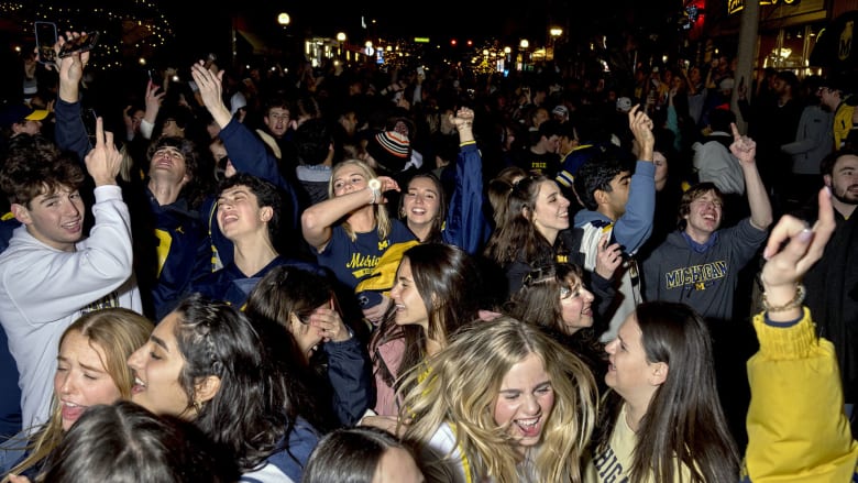 Michigan Wolverines fans celebrate after winning college football championship