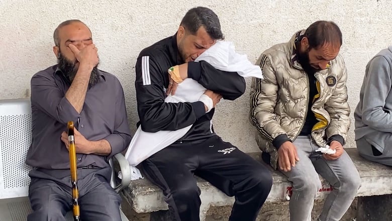 Gazan father bids tearful farewell to dead wife and daughters