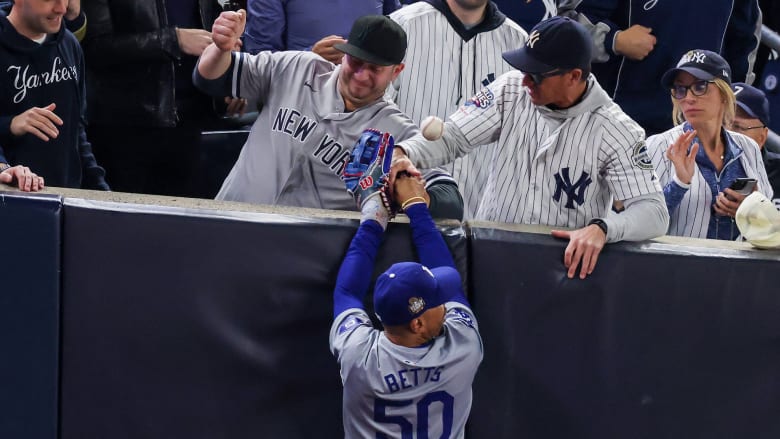 Yankee fans interfere with a foul ball caught by Mookie Betts