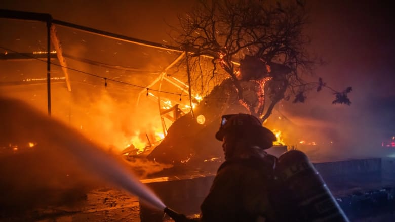California wildfire scorches abandoned cars left behind by evacuees