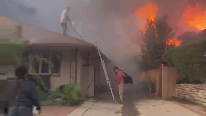 Watch: California neighbors work to stop flames spreading between homes