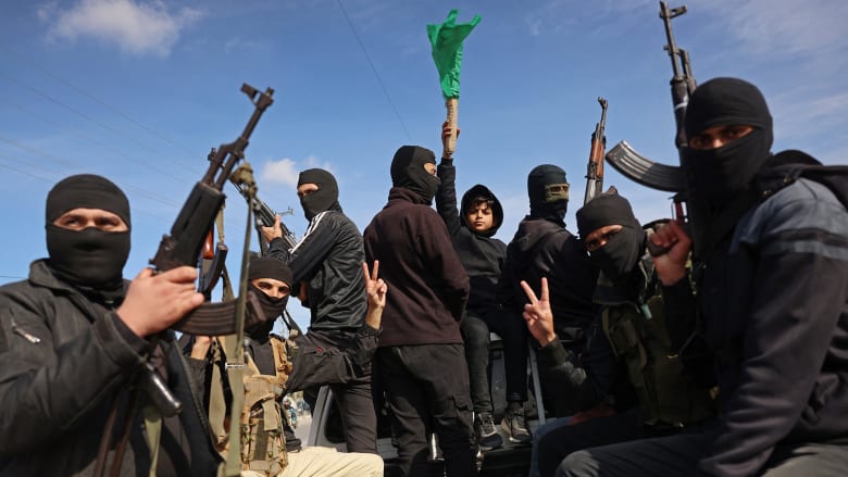 Armed Hamas militants celebrate ceasefire deal in Gaza