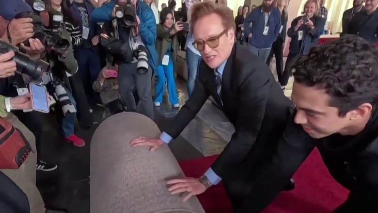 Watch Conan O’Brien (literally) roll out the 2025 Oscars red carpet