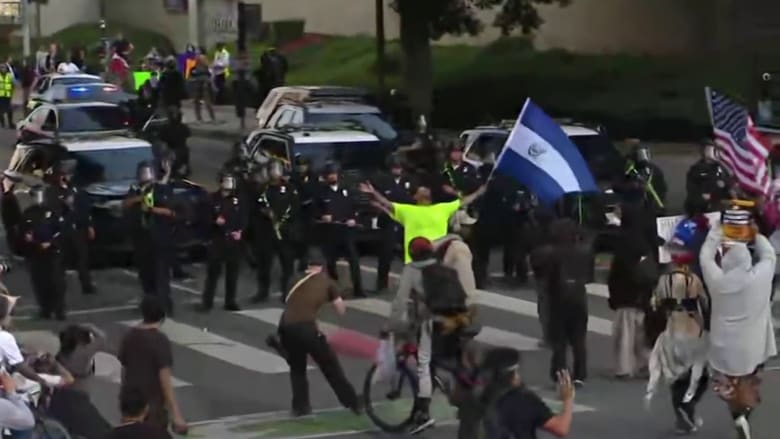 Reporter falls back with dispersed L.A. protesters amid flash-bangs, tear gas