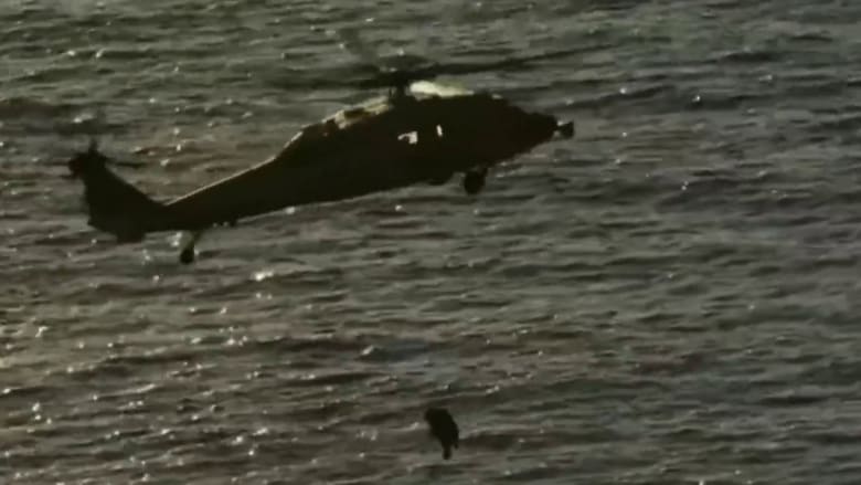 Astronauts hoisted by helicopter from splashdown site