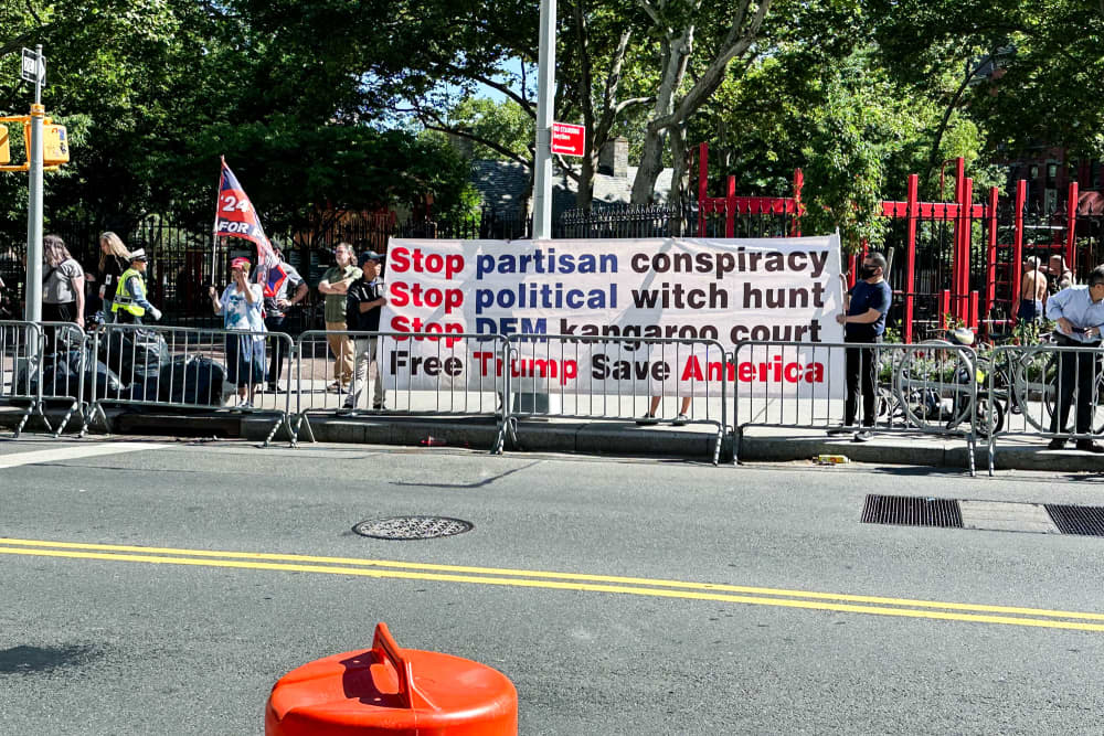 A small group of Trump supporters at the corner of Baxter and Worth