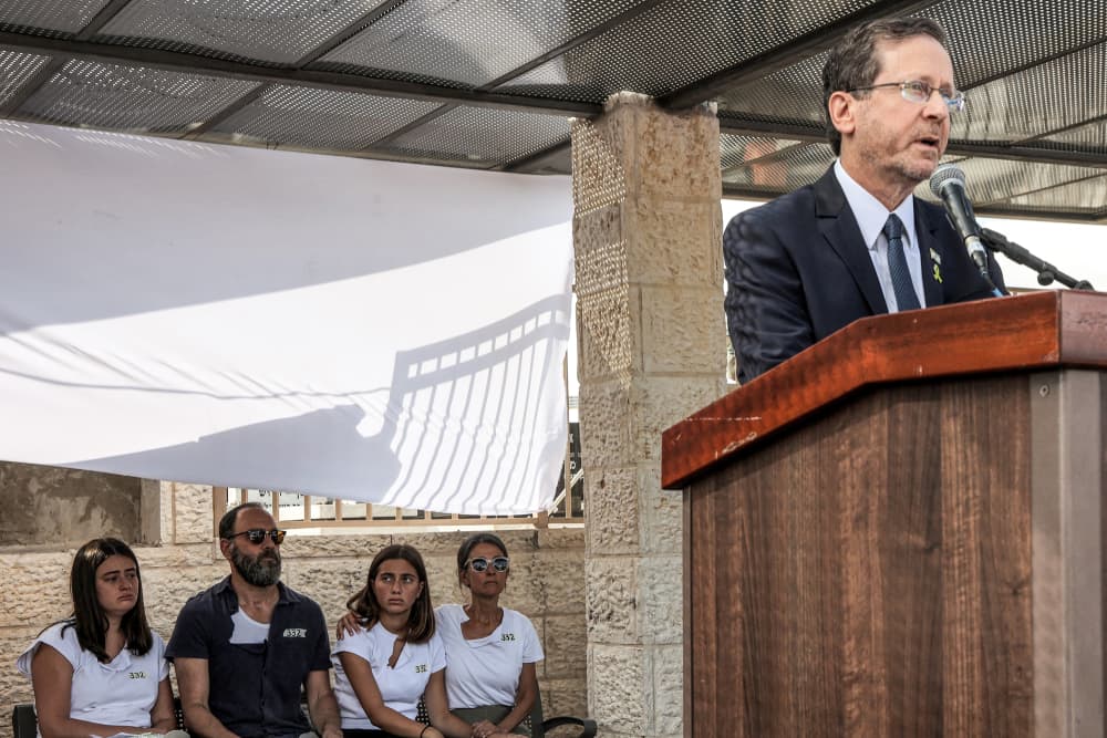 Isaac Herzog speaks at a podium