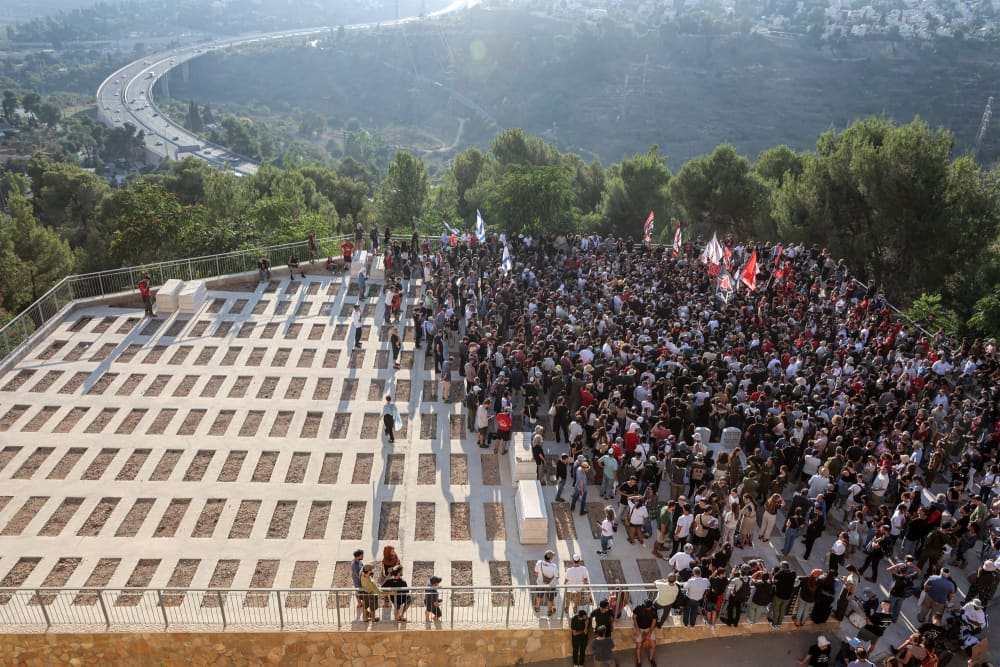 An overhead view of mourners gathered for the burial