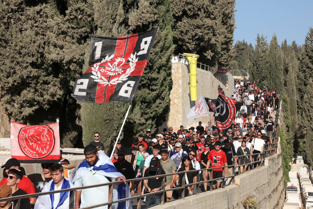 People march along a hill