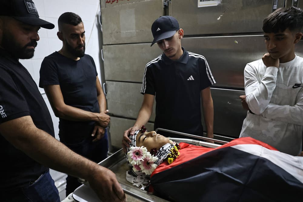 Relatives mourn over the body of 12-year-old Palestinian Hatem Sami Ghaith, who died as a result of wounds sustained during an Israeli raid, in Ramallah in the West Bank on Oct. 7, 2024.