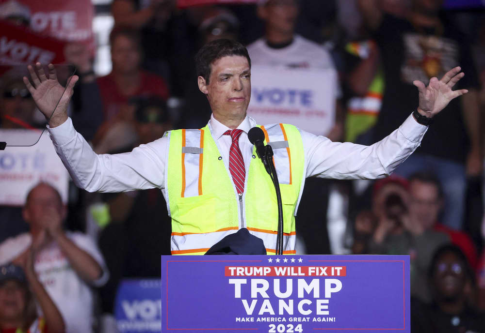 Republican Senate candidate Sam Brown wears a reflective vest at a Trump rally