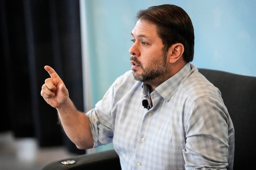 Ruben Gallego speaks while seated and pointing