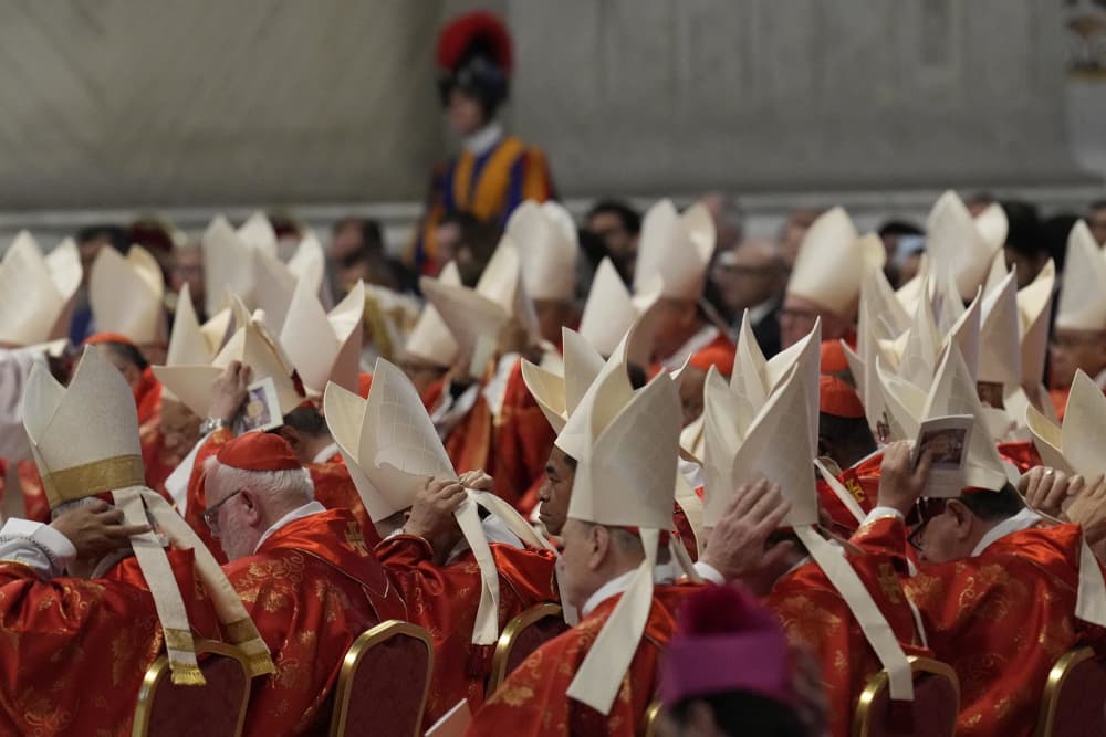 Cardinals adjust their mitre hats during a final Mass celebrated by cardinals inside St. Peter's Basilica before the conclave to elect a new pope on Wednesday, May 7, 2025.