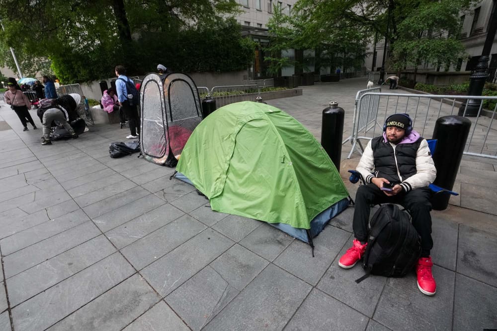 People wait in line to enter federal court for Sean "Diddy" Combs' sex trafficking trial in New York City on May 14, 2025.