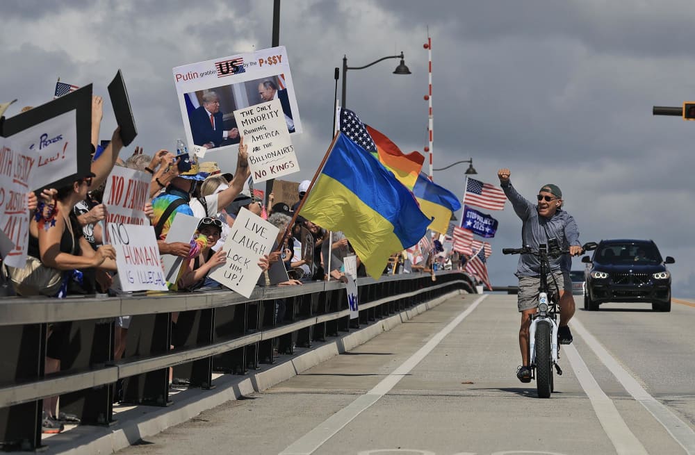 Protesters march near President Donald Trump's Mar-a-Lago home during a "No Kings Day" protest on June 14, 2025 in West Palm Beach, Fla.