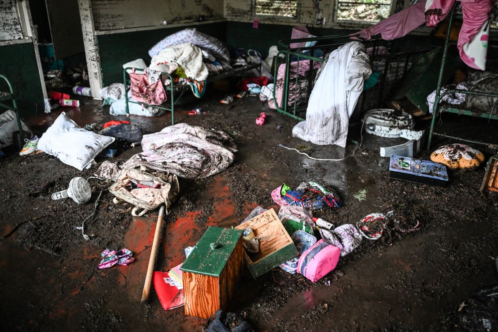 A muddy room with items strewn everywhere on the floor
