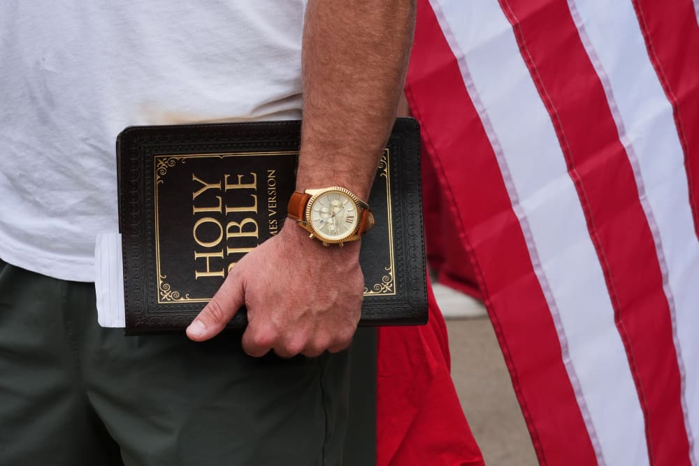 A hand holding a bible
