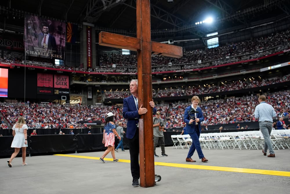 Dan Beazley holds a giant wooden cross