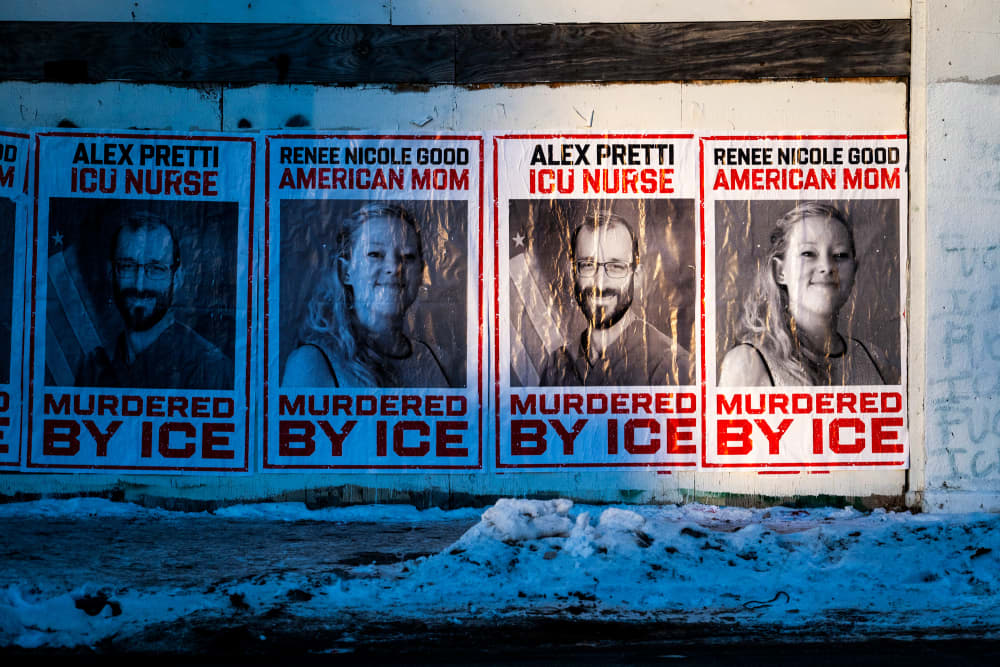 Posters of Alex Pretti and Renee Good, saying they were murdered by ICE, are seen pasted to the wall of a building outside