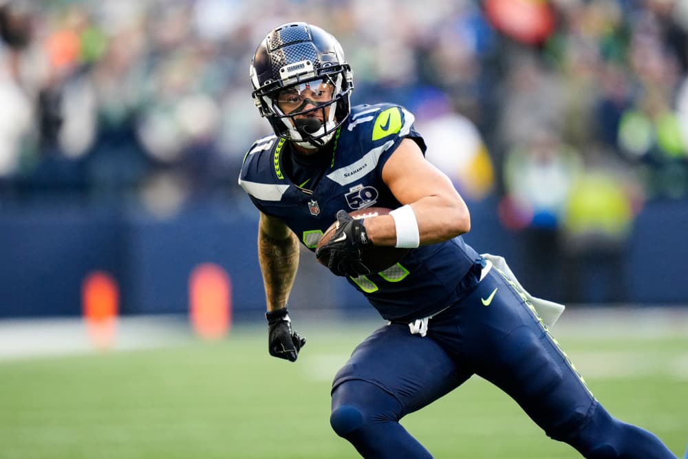 Jaxon Smith-Njigba runs with the football on the field