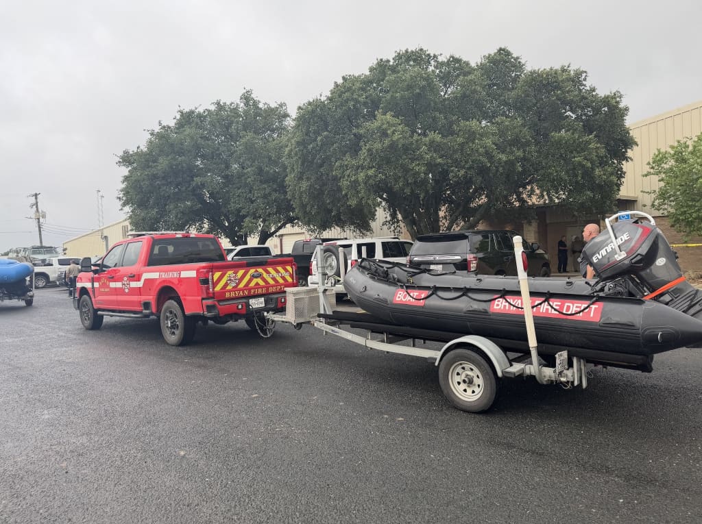 A police truck carrying a boat behind it