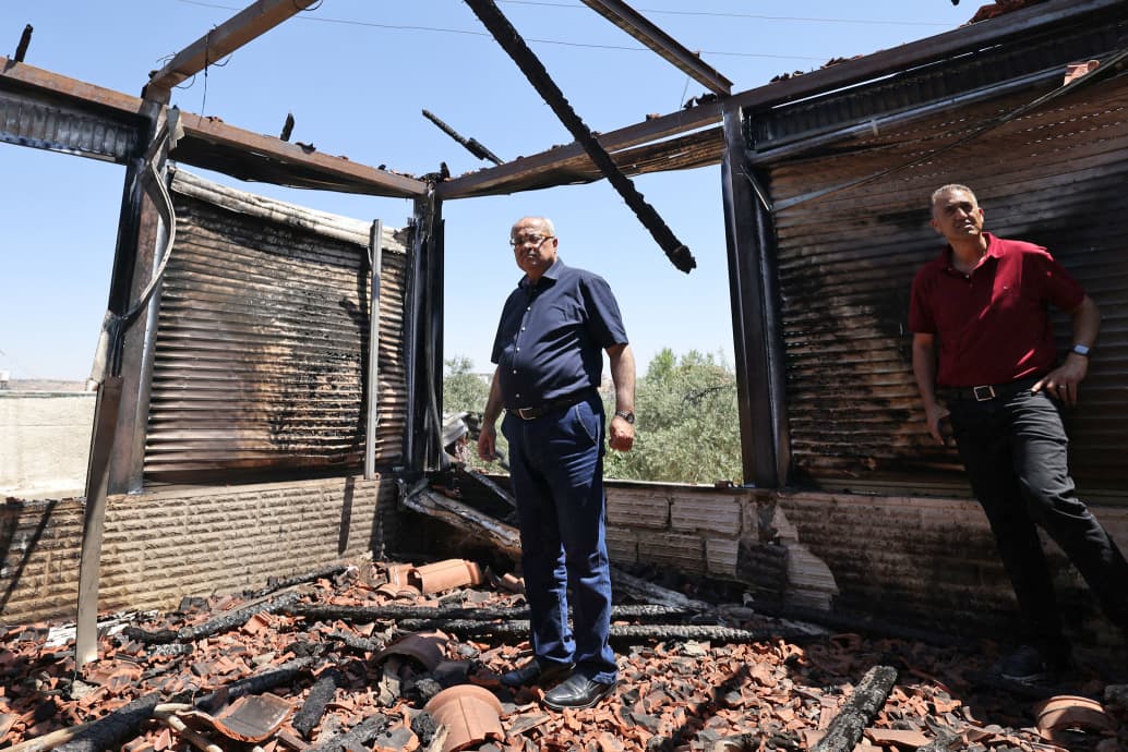 Ahmed Tibi, a Palestinian member of Israel's Knesset, inspects the site of an attack by Israeli settlers on the village of Turmus Ayya, near the occupied West Bank city of Ramallah, on June 24, 2023.