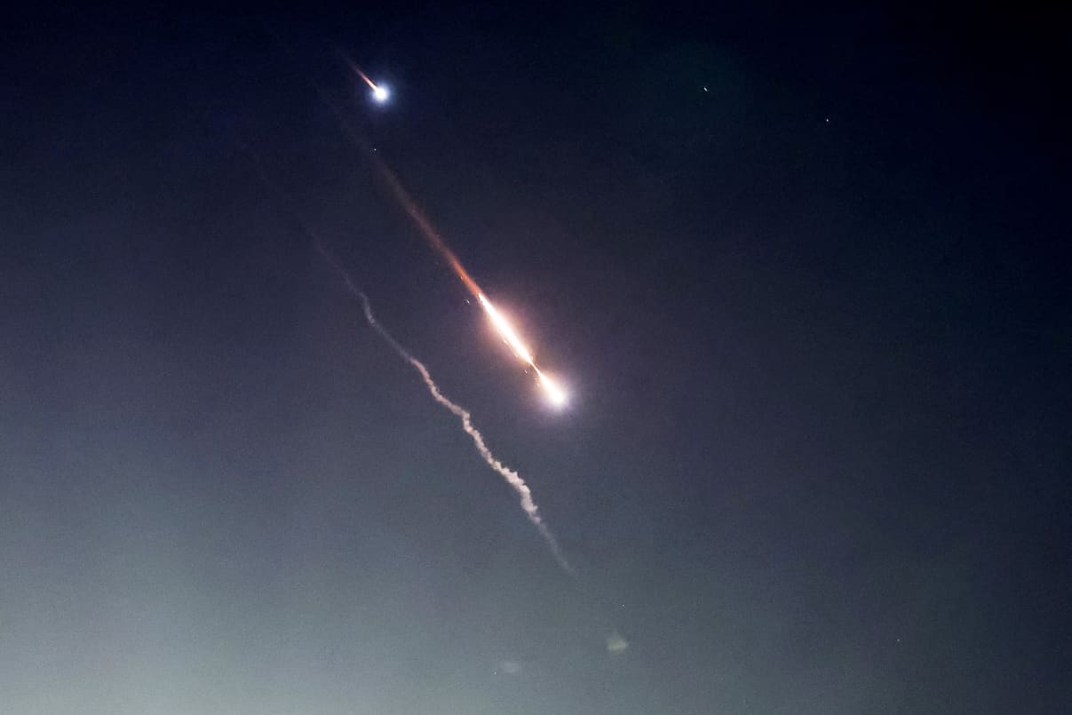 Objects are seen in the sky above Jerusalem after Iran launched drones and missiles towards Israel, in Jerusalem