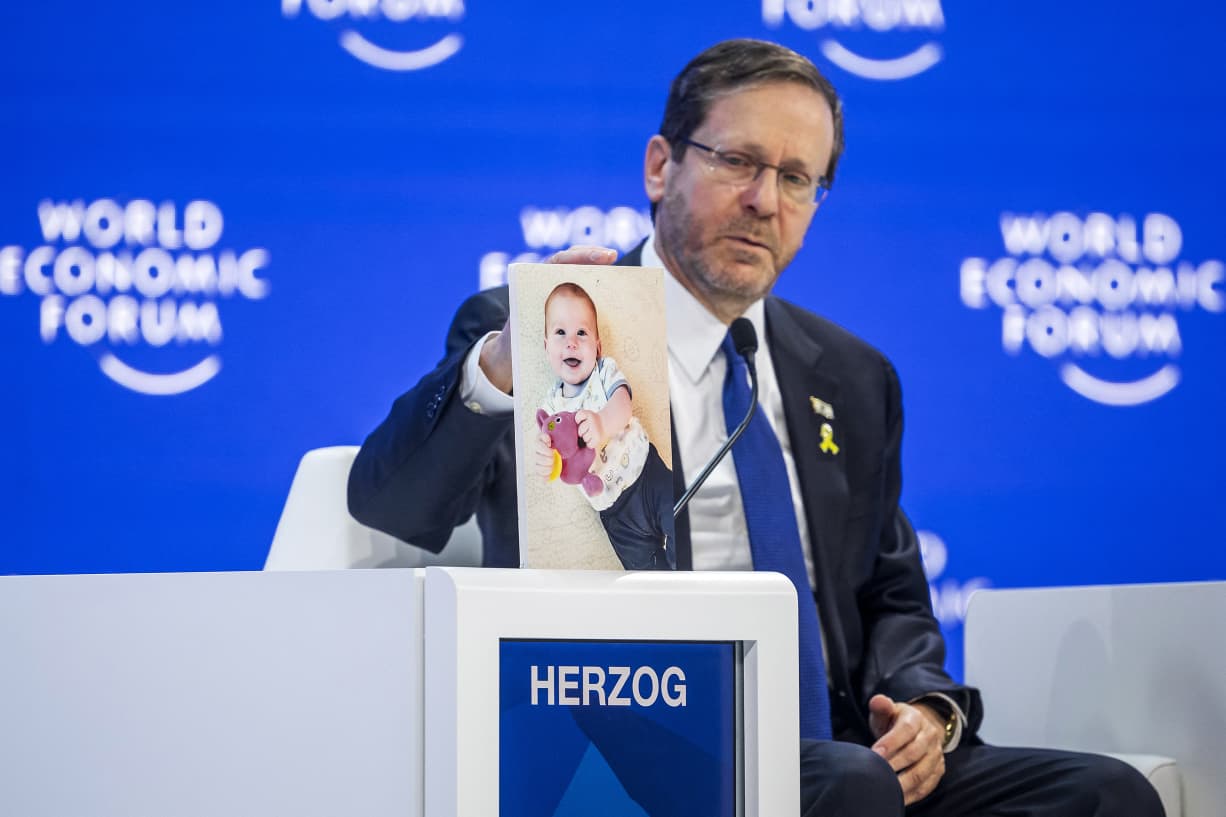 shows a photograph of 10-month-old baby Kfir Bibas