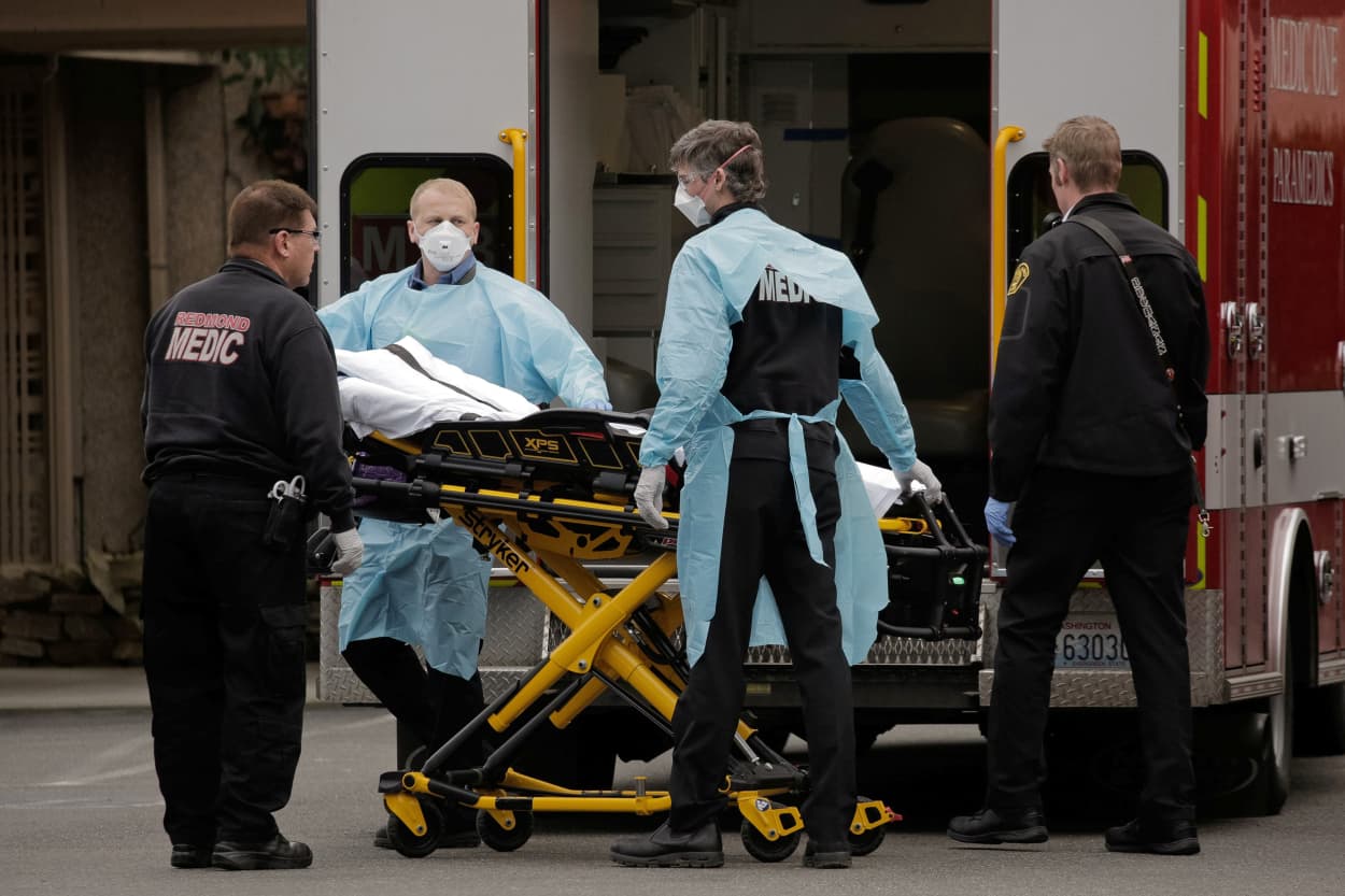 Image: Medics prepare to transfer a patient on a stretcher to an ambulance at the Life Care Center of Kirkland, the long-term care facility linked to the two of three confirmed coronavirus cases in the state, in Kirkland