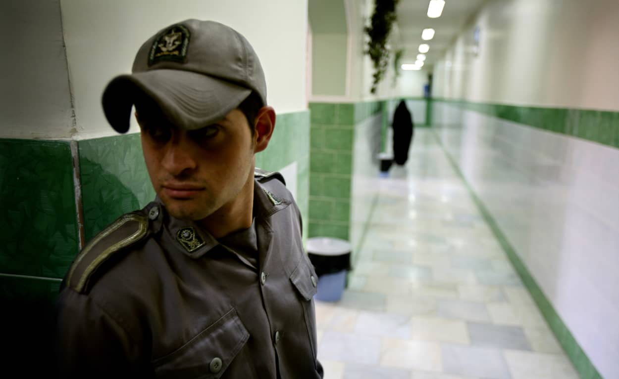 Image: Prison guard stands along corridor in Tehran's Evin prison