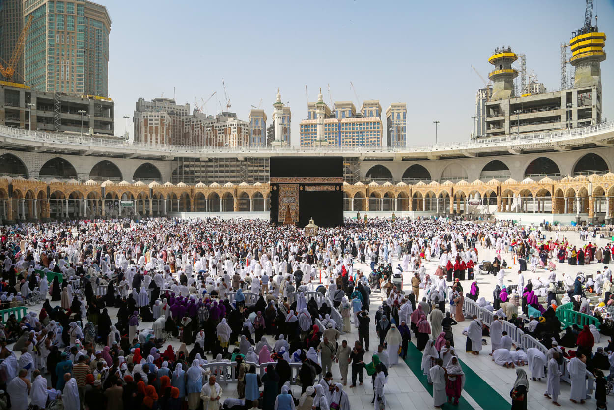 Image: Muslim pilgrims wear protective face masks, following the outbreak of the coronavirus, as they pray at Kaaba in the Grand mosque in the holy city of Mecca