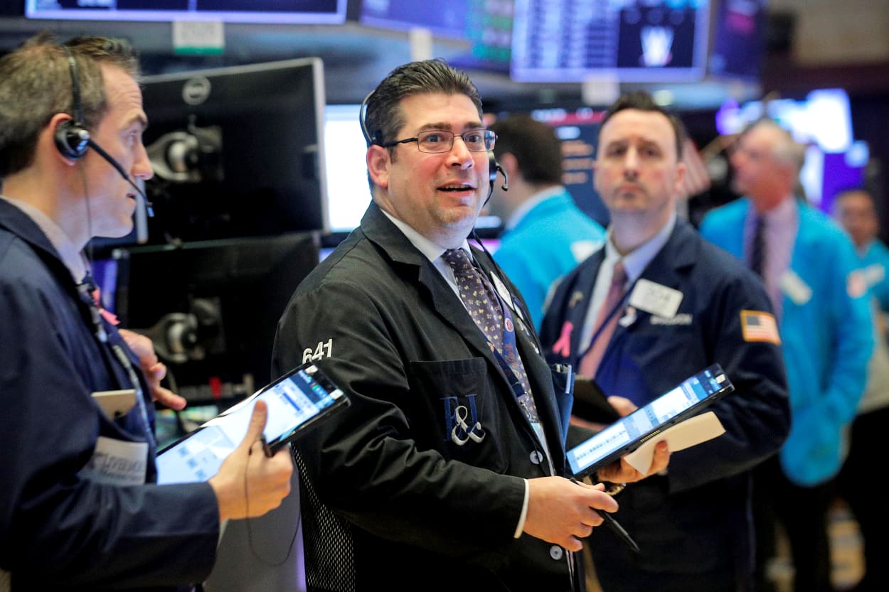 Image: Traders work on the floor at the NYSE in New York