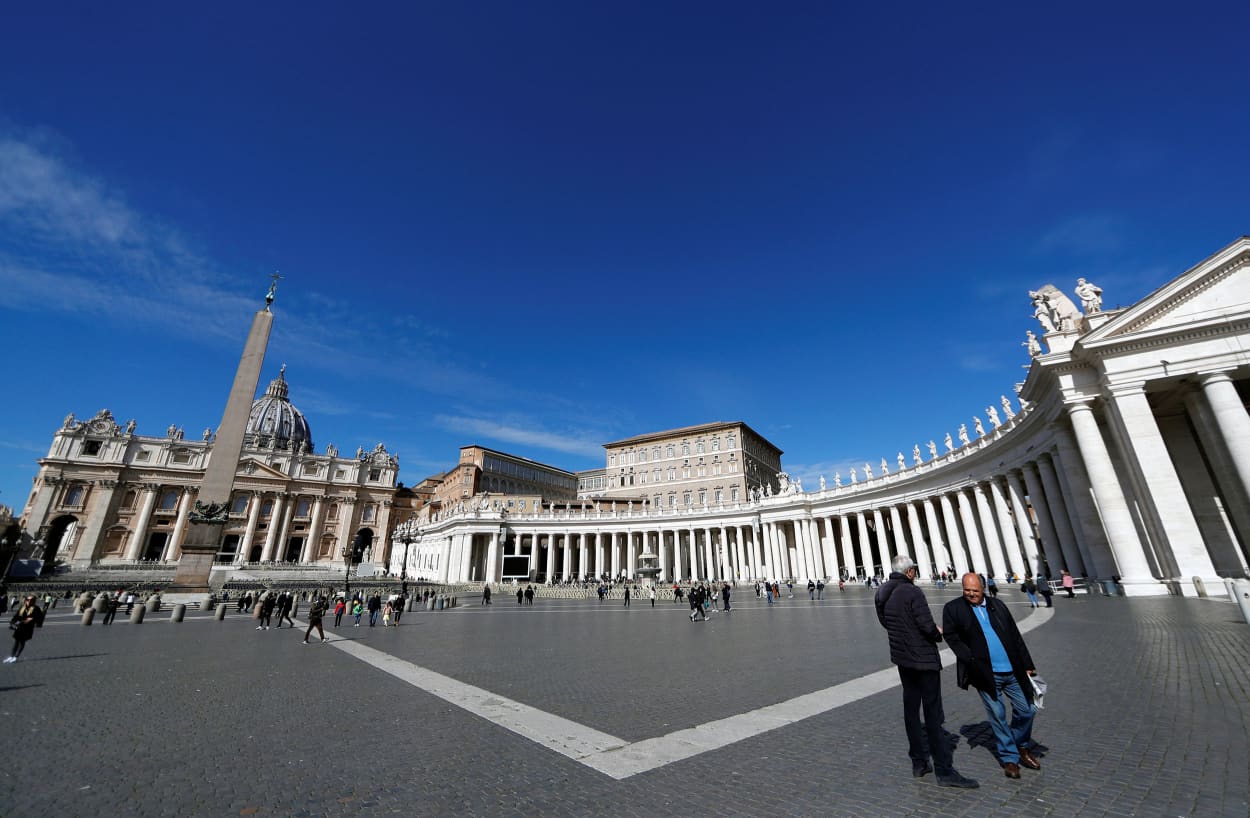 Image: People walk in Saint Peter's Square, after the Italian government decree to close schools, cinemas, and urge people to work from home and not stand closer than one metre to each other at the Vatican,