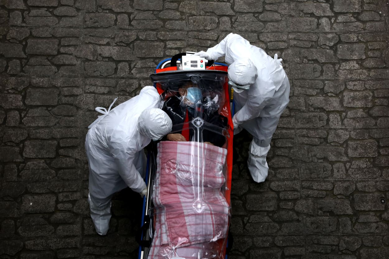 Image: Medical staff move a patient infected with coronavirus from an ambulance to a hospital in Seoul, South Korea, on Monday. According to the Korea Centers for Disease Control and Prevention, 69 new cases were reported on Monday, with the death toll r