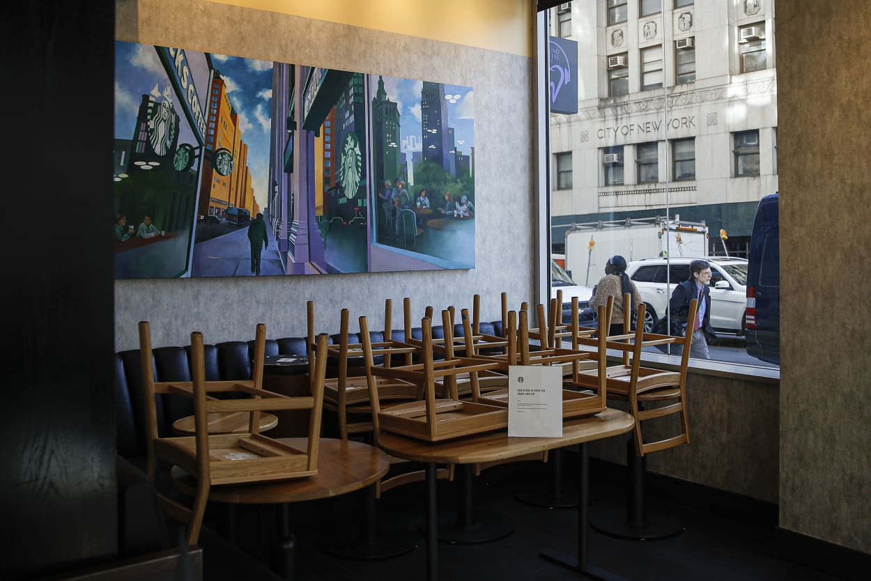 Chairs are stacked in a Starbucks coffee shop