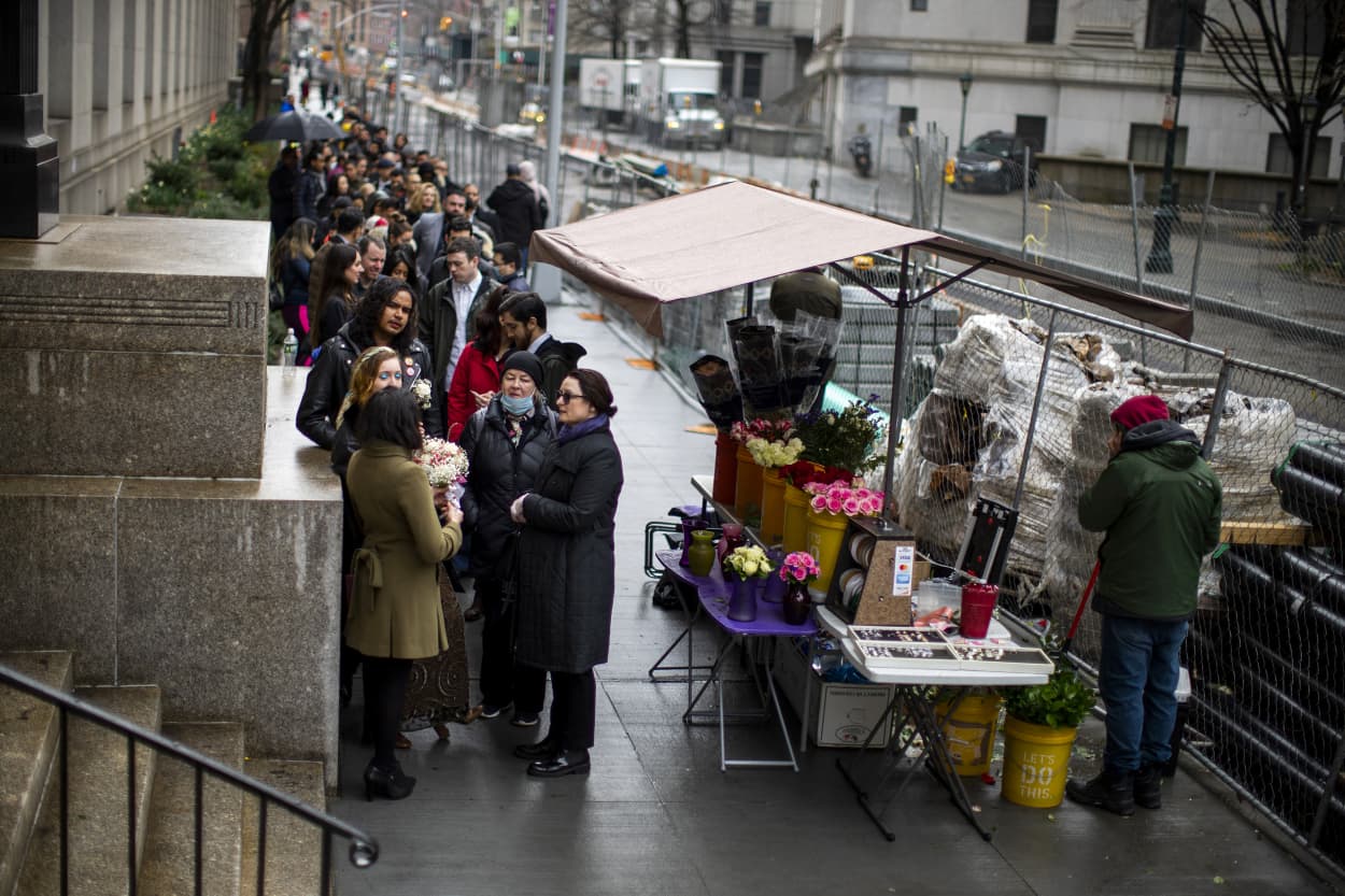 Image: People wait to enter the City Clerk's Office in New York to get married on March 17, 2020.