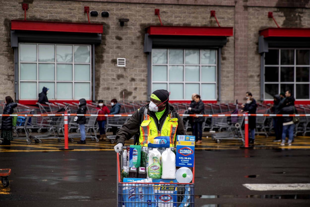 Image: A shopper pushes their cart full of supplies from a Costco in Brooklyn on March 19, 2020.