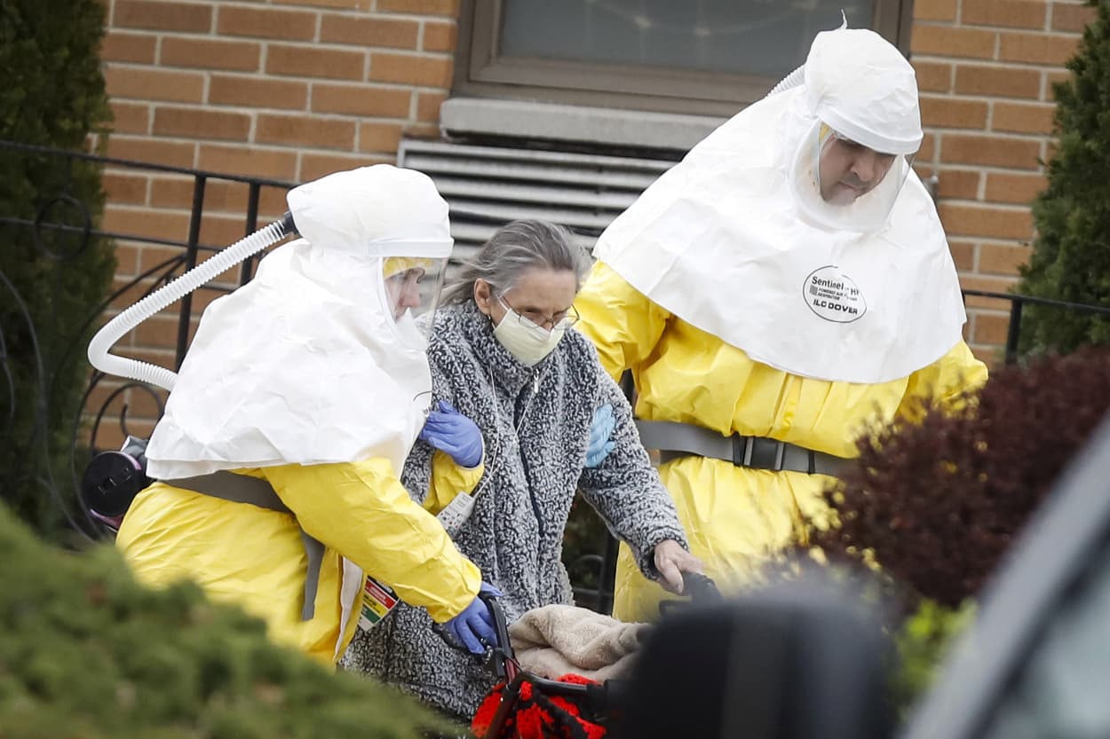 Image: Medical officials aid a residents from St. Joseph's nursing home to board a bus, after a number of residents tested positive for coronavirus disease (COVID-19) in Woodbridge, New Jersey