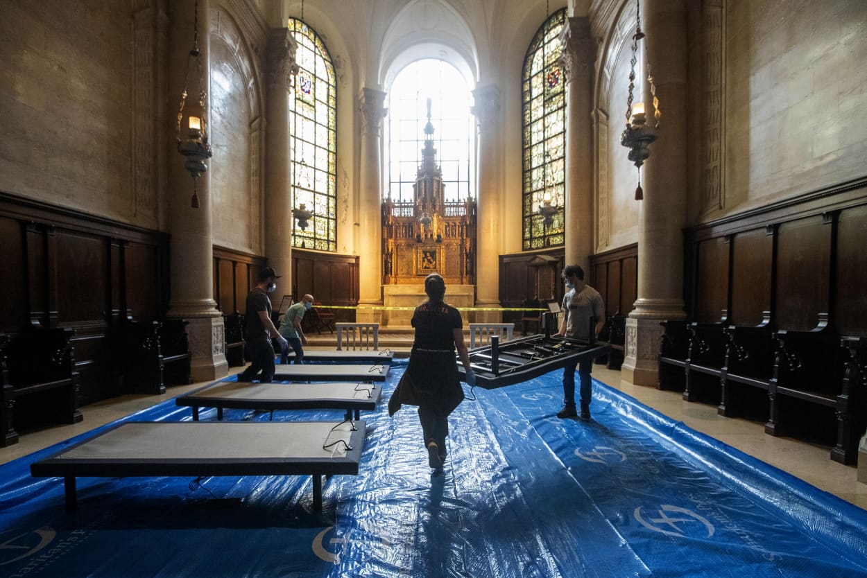 Image: Volunteers place beds to construct a coronavirus field hospital at the Cathedral of St. John the Divine in New York on April 8, 2020.