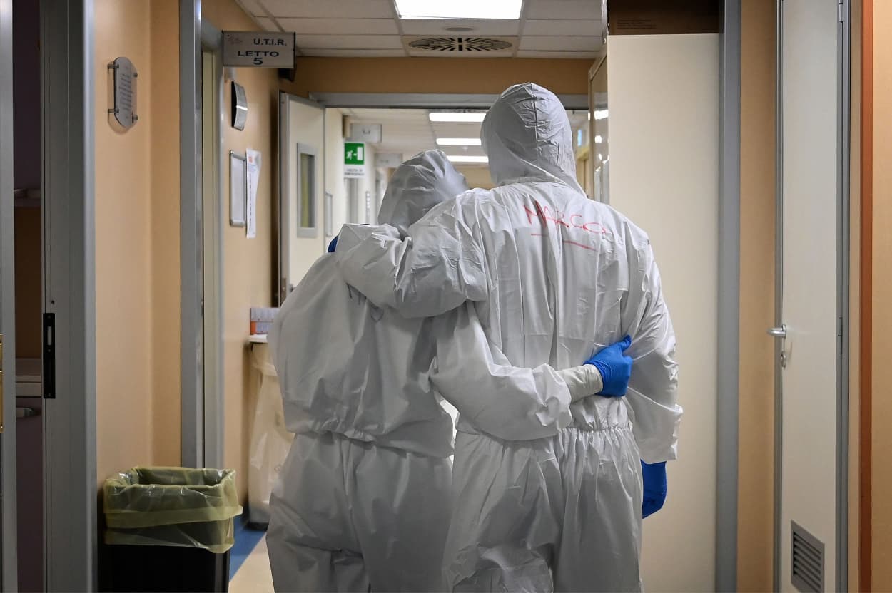 Image:At doctor and nurse embrace at the end of their shift in a corridor of an intensive care unit treating COVID-19 patients at the San Filippo Neri hospital in Rome on Monday.