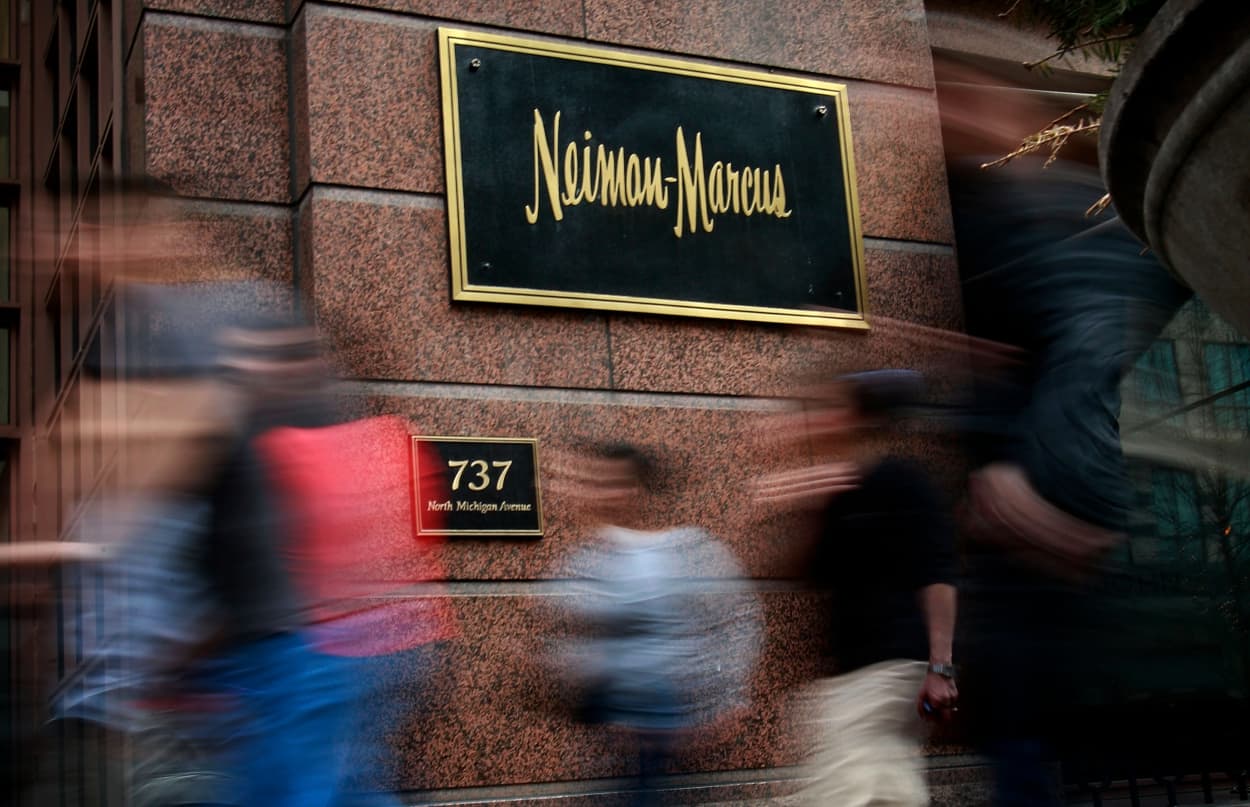 Image: Pedestrians walk past a Neiman Marcus store in Chicago in 2009.