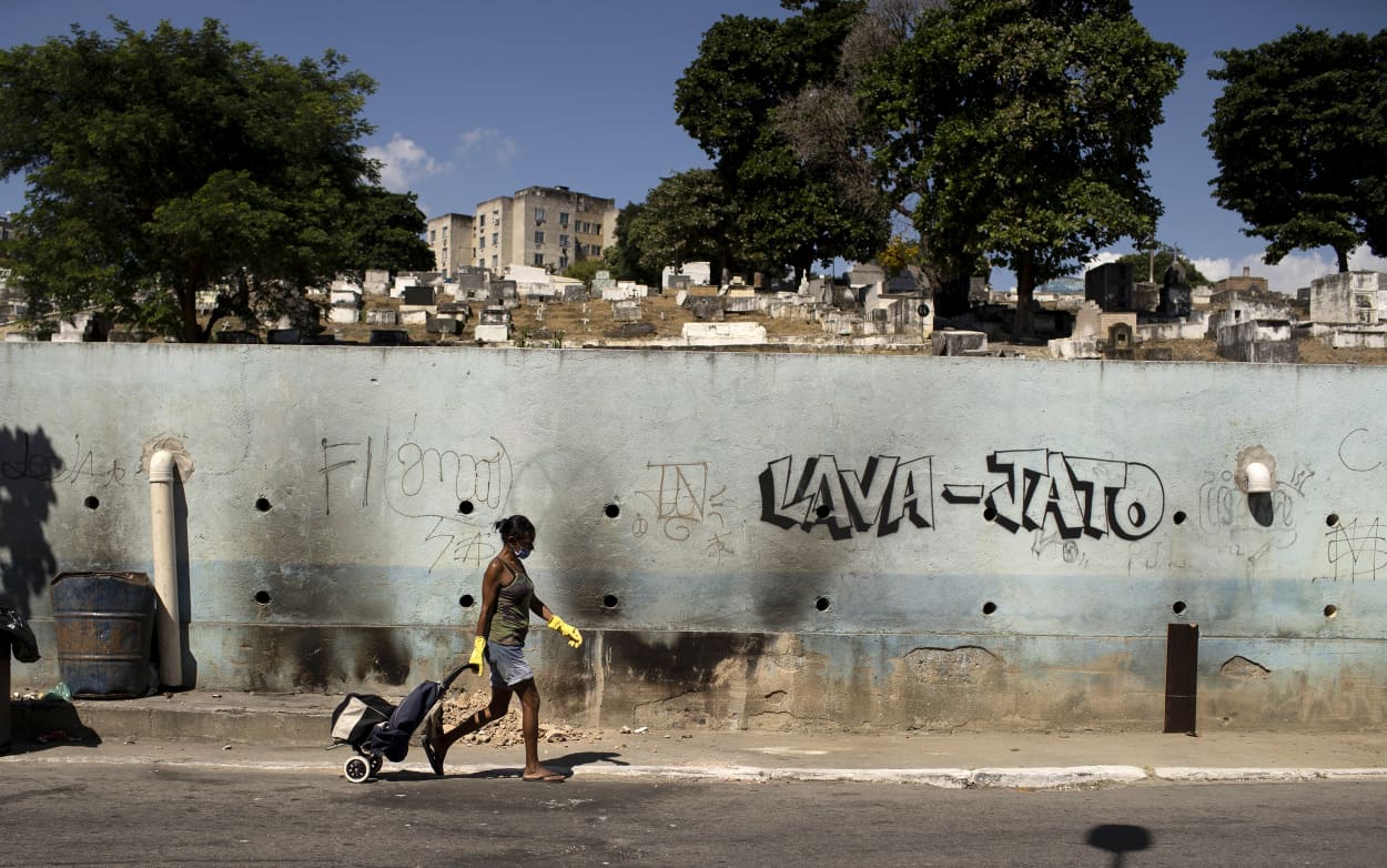 Image: A woman wearing a mask walks past Nossa Senhora das Gracas cemetery in Rio de Janeiro, Brazil, on April 27, 2020.