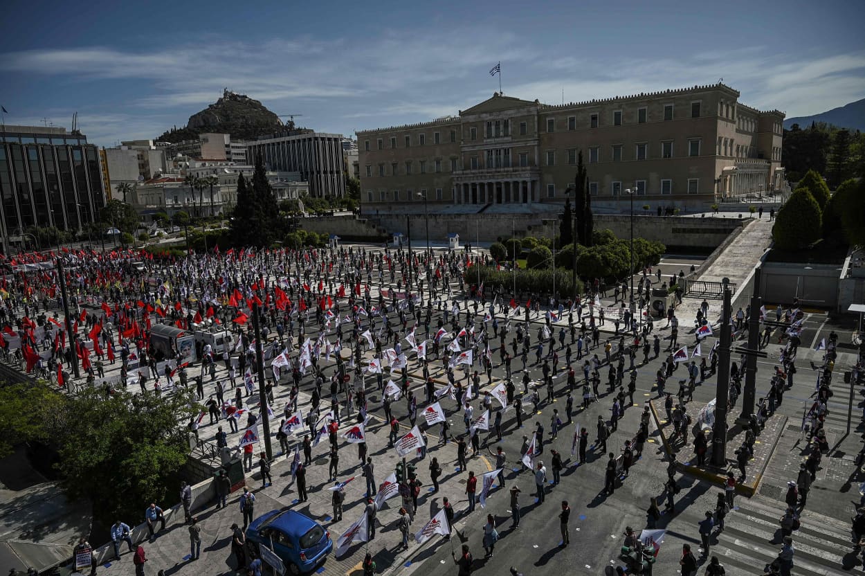 Image: Members of the Greek Labour Union (PAME), wearing protective masks and respecting the social distances against the spread of the novel coronavirus, COVID-19, protest in front of the Greek Parliament during the Labour Day demonstration in Athens