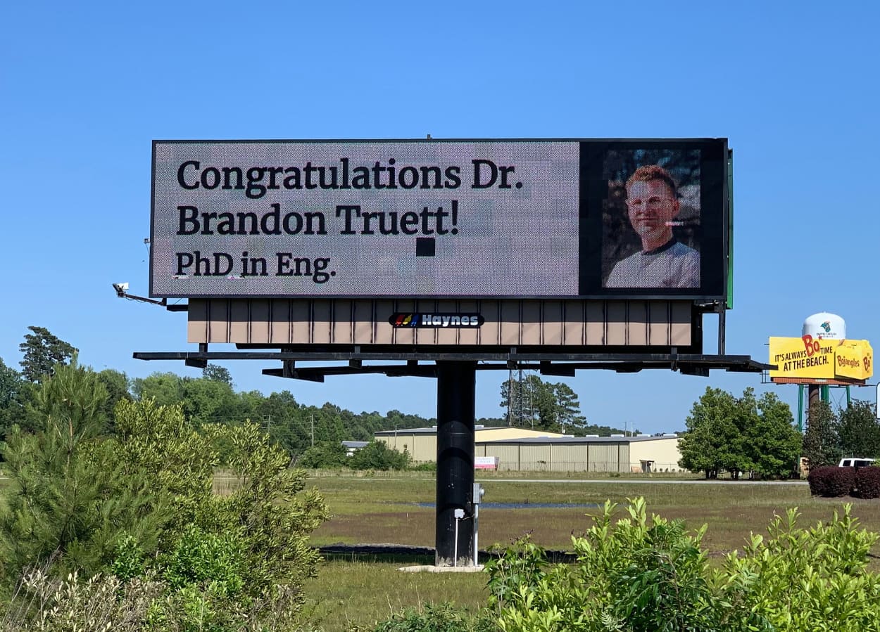 Brandon Truett's parents celebrated his PhD on a billboard