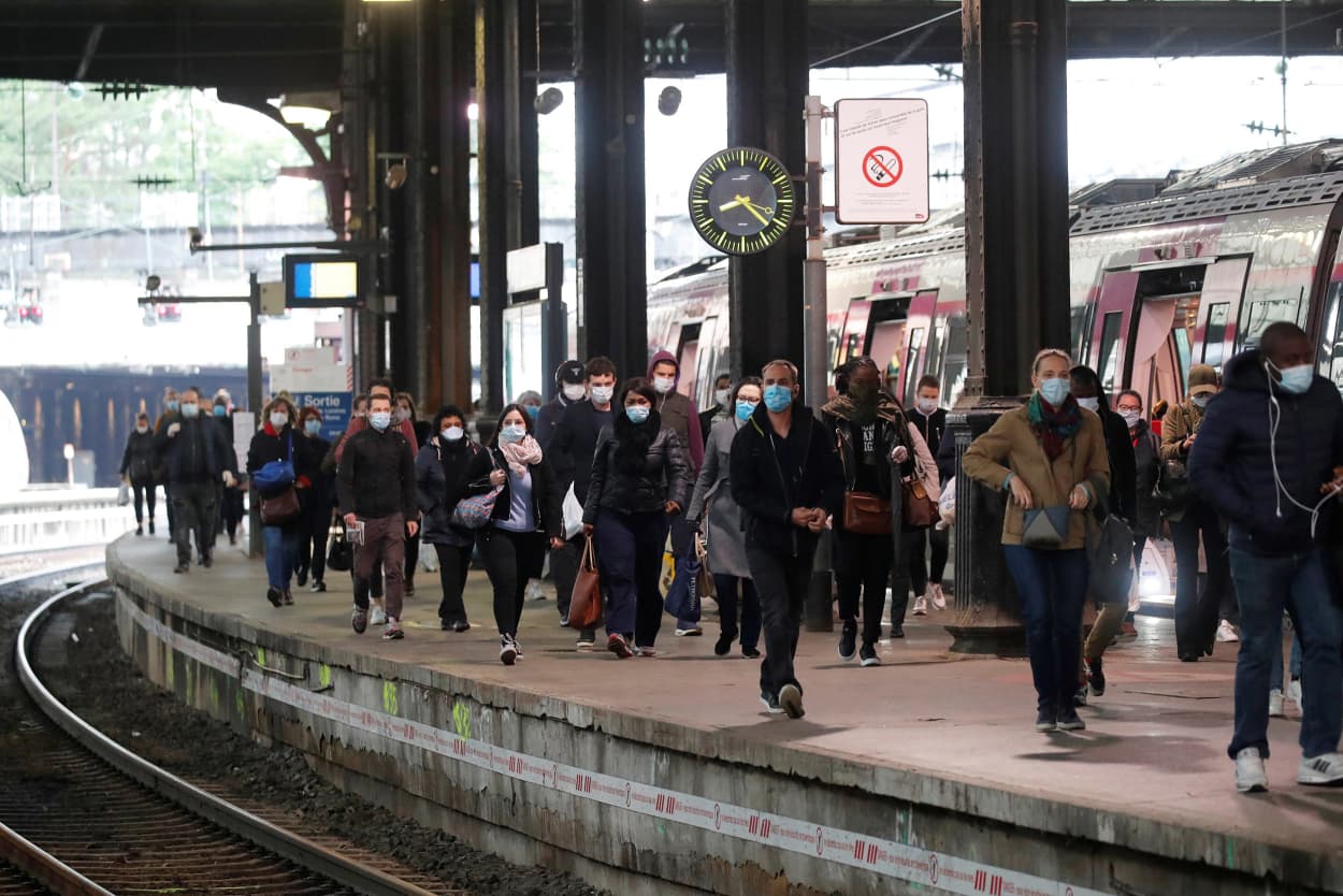 Image: Commuters, wearing protective face masks, walk on a platform at the Saint-Lazare train station in Paris, on the first day mask usage is mandatory in public transport, after France begun a gradual end to a nationwide lockdown due to the coronavirus