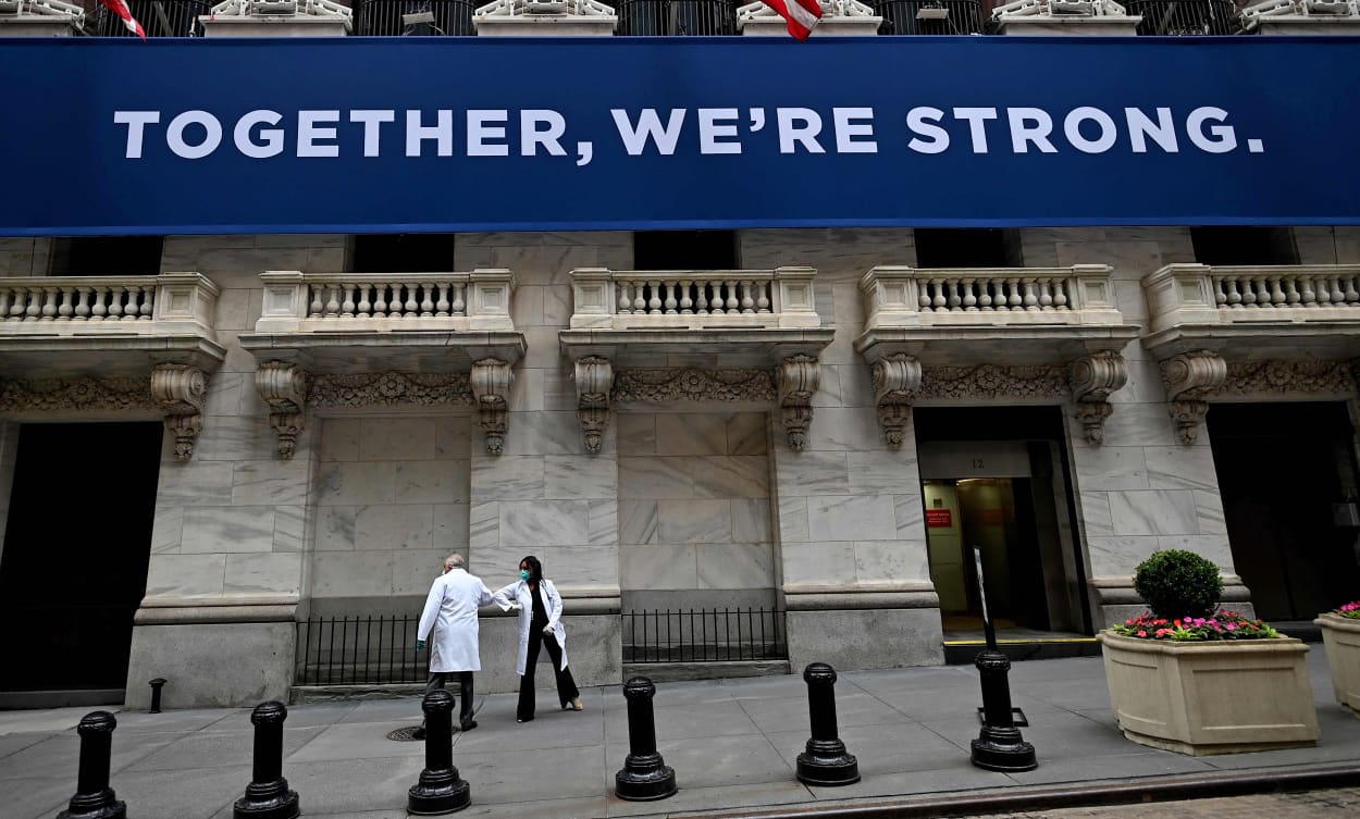 Medical workers arrive before the opening bell at the New York Stock Exchange on May 26, 2020.