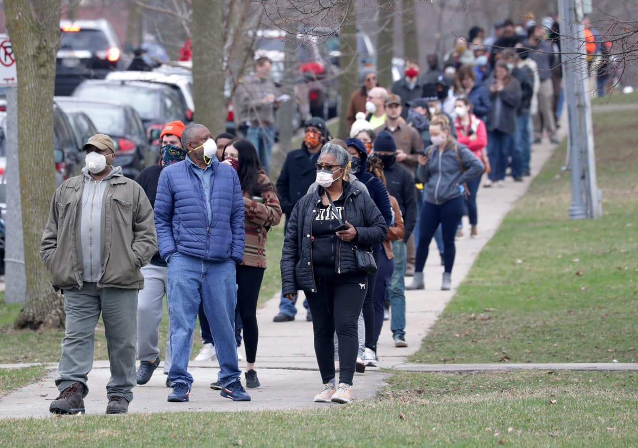 Michael Singleton and his wife Gladys wait in a line, which continued a few blocks south of the polling location in Milwaukee