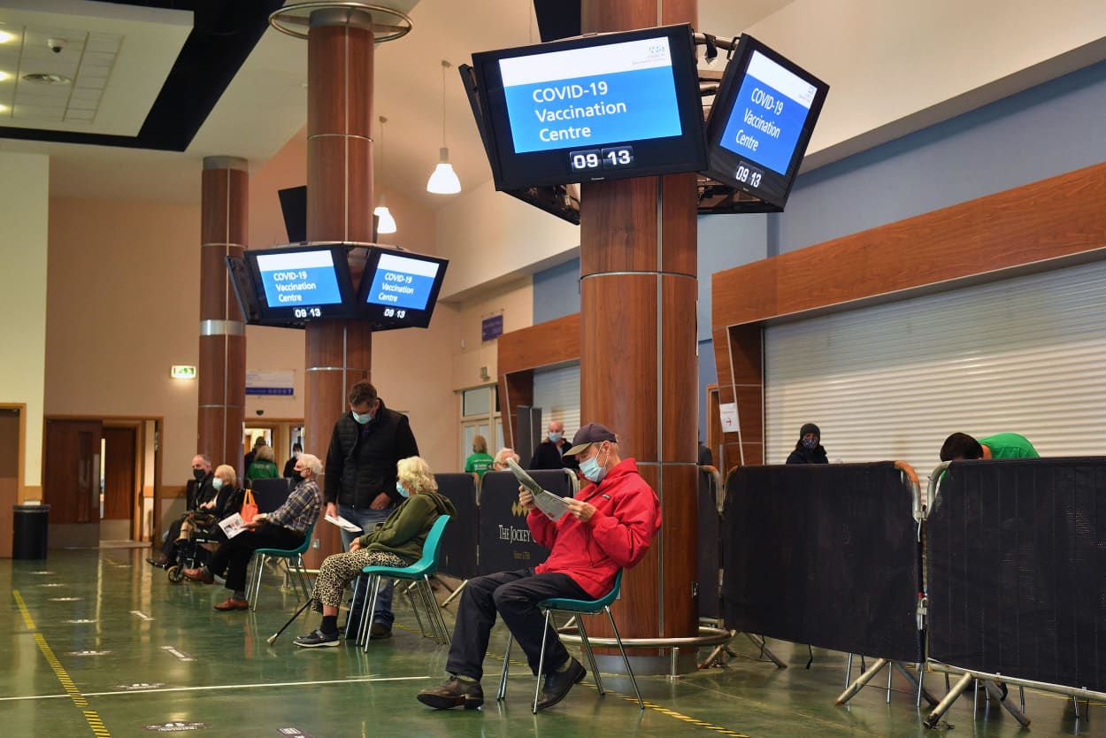 Image: Members of the public wait for an Oxford/AstraZeneca Covid-19 vaccine at a mass vaccination center at Epsom racecourse in Epsom, southern England