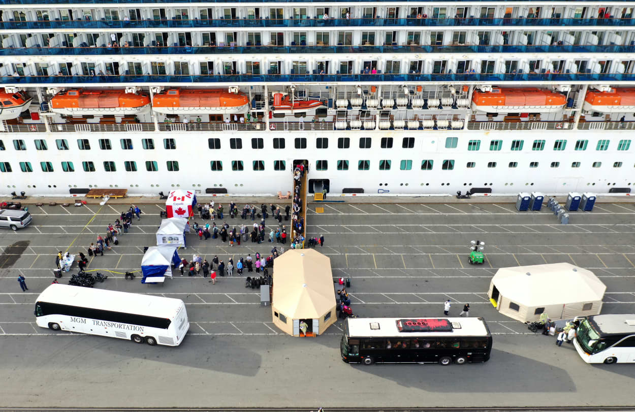 Image: Passengers disembark from the Princess Cruises Grand Princess as it sits docked in the Port of Oakland